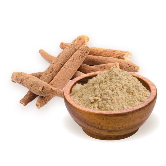 Ashwagandha powder in a brown wooden bowl with ashwaghanda stick stacked next to the bowl on a white surface 
