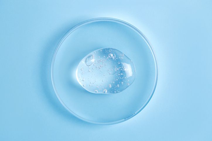 Vegetable glycerin on a petri dish on a blue surface