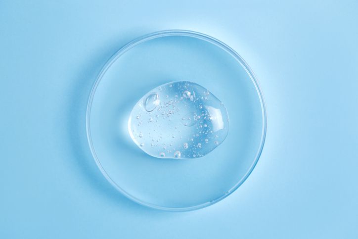 Vegetable glycerin on a petri dish on a blue surface 